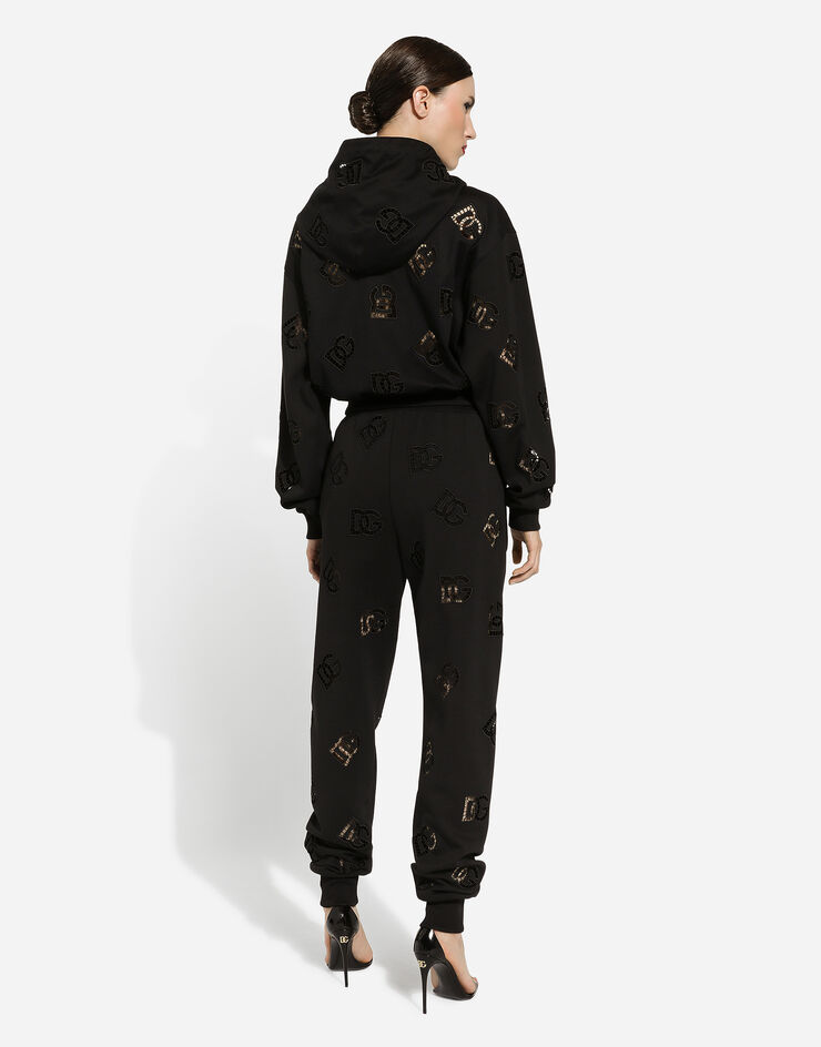 Dolce & Gabbana Pantalon de jogging en jersey avec broderie ajourée logo DG Noir FTCP7ZGDB9U