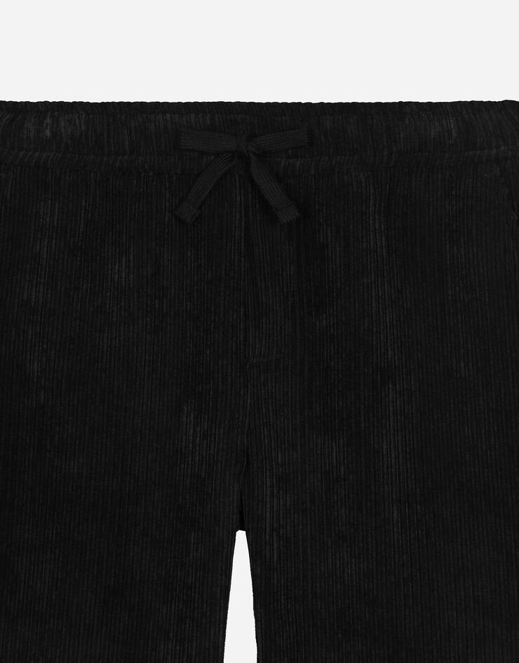 Dolce & Gabbana Pantaloni in velluto a coste con placca logata Nero L44P65FUWDL