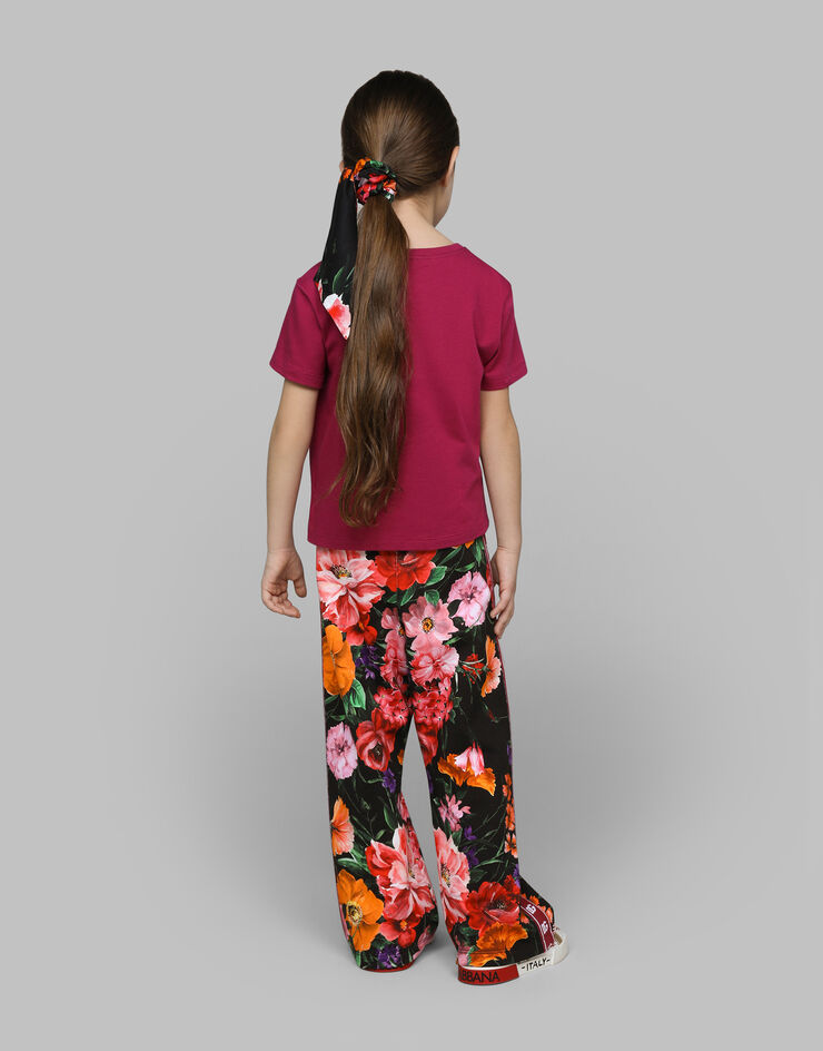 Dolce & Gabbana Jersey jogging pants with floral print over a black background Print L5JPE9HS7O4