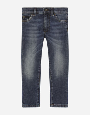 Dolce & Gabbana Узкие джинсы из обработанного эластичного денима синего цвета Отпечатки L4JQT4II7EF