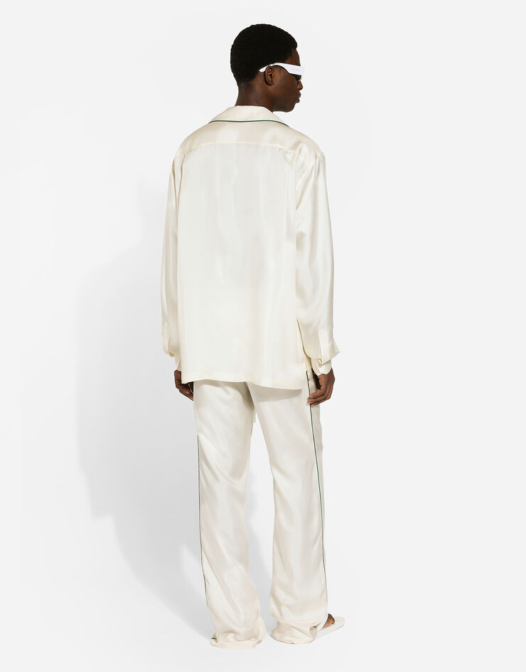 Dolce & Gabbana سروال للركض حرير بشعار DG مطرز أبيض GVRMAZFU1S4