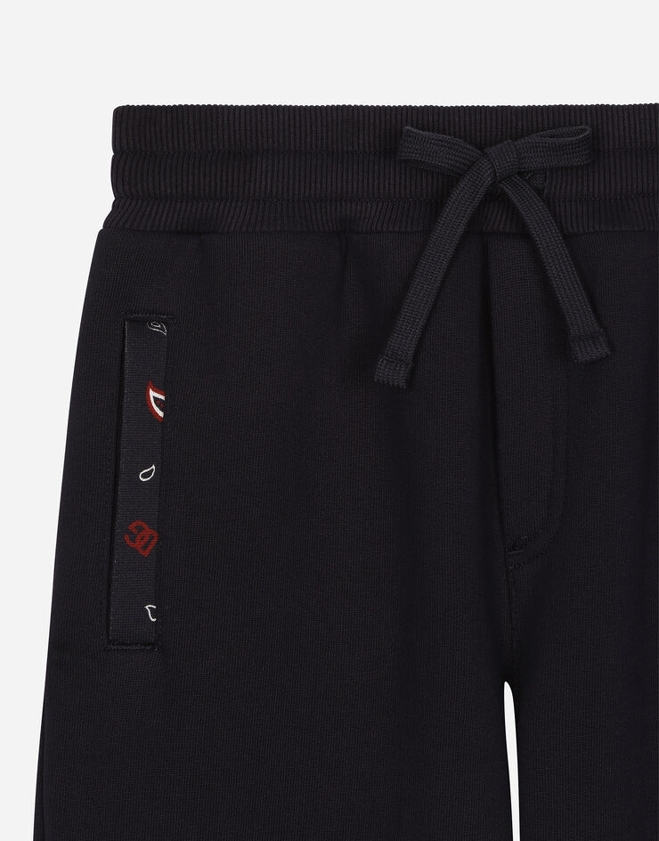 Dolce & Gabbana Pantalón de chándal en punto con detalles de estampado de bandana Azul L4JPJEG7NQN