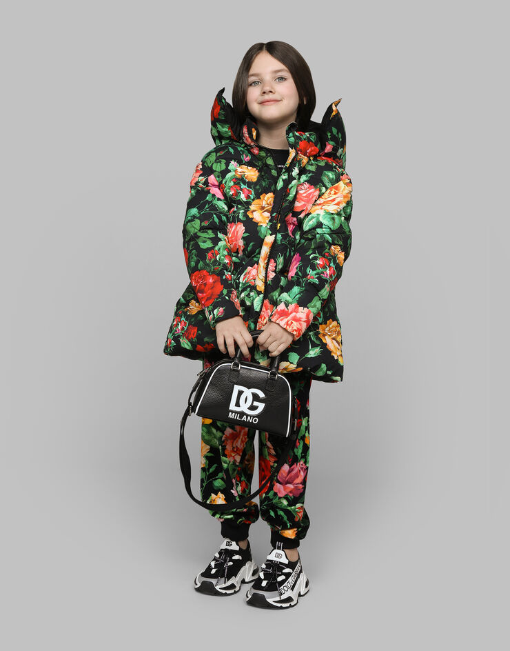 Dolce & Gabbana Long nylon down jacket with rose print over a black background Print L5JBQ5ISMIB